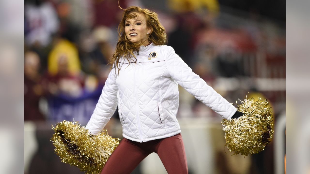 A Washington Commanders cheerleader performs during the second