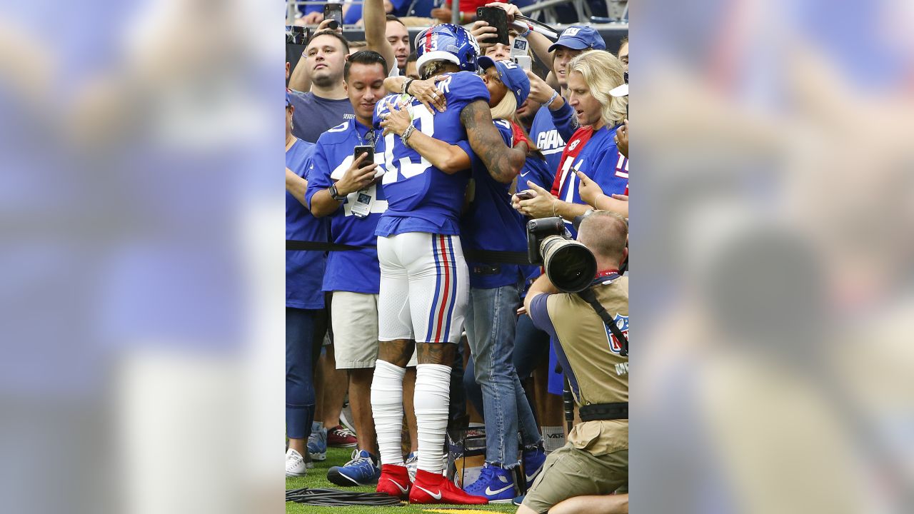 Green Bay Packers quarterback Aaron Rodgers hugs his mother Darla Rodgers  before taking the…