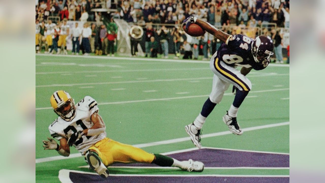 San Francisco 49ers wide receiver Randy Moss (84) catches a pass over Green  Bay Packers cornerback Tramon Williams (38) during the first half of an NFC  divisional playoff NFL football game in