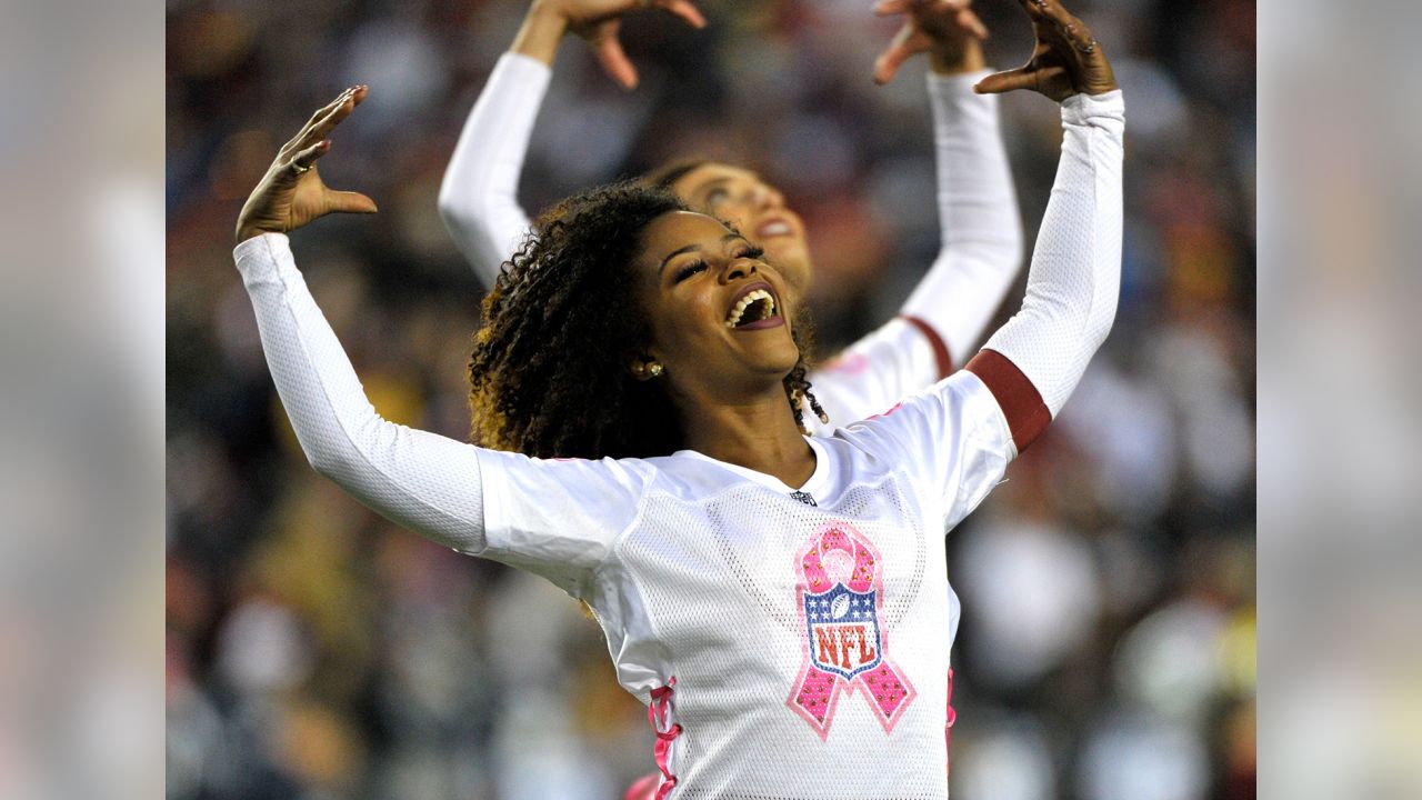 A Washington Commanders cheerleader performs during the first half of an  NFL preseason football game between the Washington Commanders and the  Baltimore Ravens, Monday, Aug. 21, 2023, in Landover, Md. The Commanders