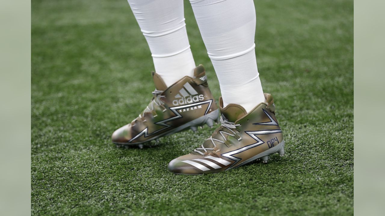 Dallas Cowboys' Dak Prescott (4) wears a cap styled with the Salute To  Service campaign logo as he warms up before an NFL football game against  the Kansas City Chiefs on Sunday