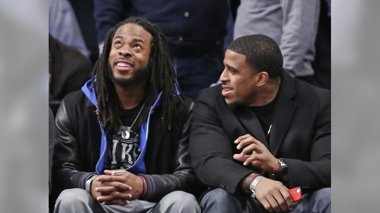 NFL players and coaches take in the NBA