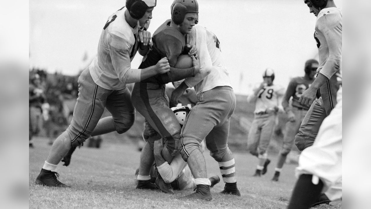 Halfback Doak Walker, right, of the Detroit Lions receives a