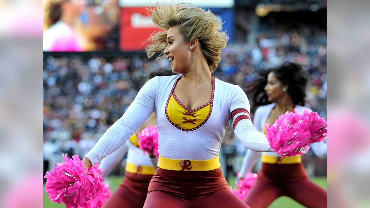 A Washington Commanders cheerleader performs during the first half of an  NFL preseason football game between the Washington Commanders and the  Baltimore Ravens, Monday, Aug. 21, 2023, in Landover, Md. The Commanders