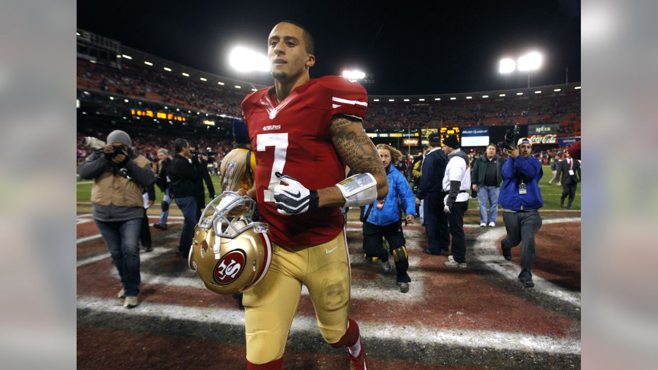 San Francisco 49ers quarterback Colin Kaepernick runs for 11 yards and a  first down during the fourth quarter of the NFC Wildcard Playoff against  the Green Bay Packers at Lambeau Field in