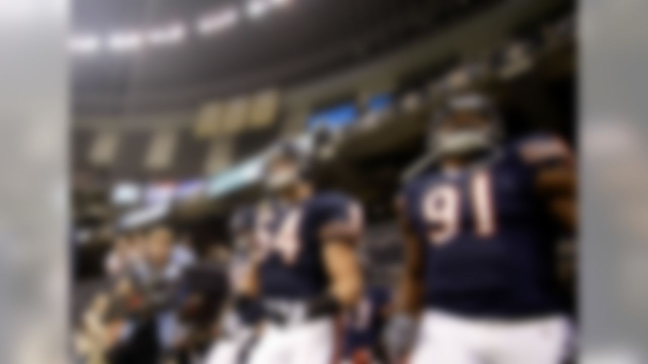 Chicago Bears middle linebacker Brian Urlacher (54) takes to the field with defensive end Julius Peppers (90) and defensive tackle Amobi Okoye (91) prior to the start of an NFL football game against the New Orleans Saints at the Louisiana Superdome in New Orleans, Sunday, Sept. 18, 2011. (AP Photo/Gerald Herbert)