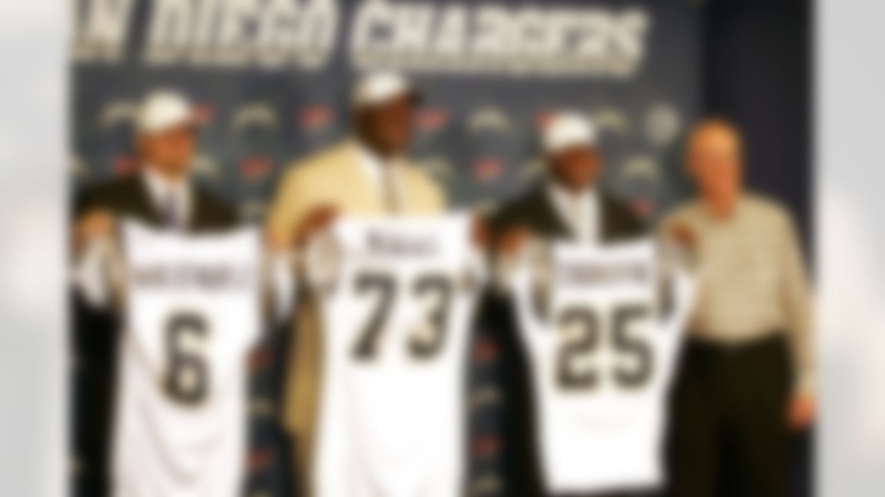 San Diego Chargers' three top draft picks, from left, Clemson quarterback Charlie Whitehurst, taken in the third round; Auburn offensive tackle Marcus McNeill, a second-round pick; and Florida State defensive back Antonio Cromartie, their first round pick, pose with head coach Marty Schottenheimer as they meet members of the media in San Diego on Sunday, April 30, 2006. (AP Photo/Jack Smith)