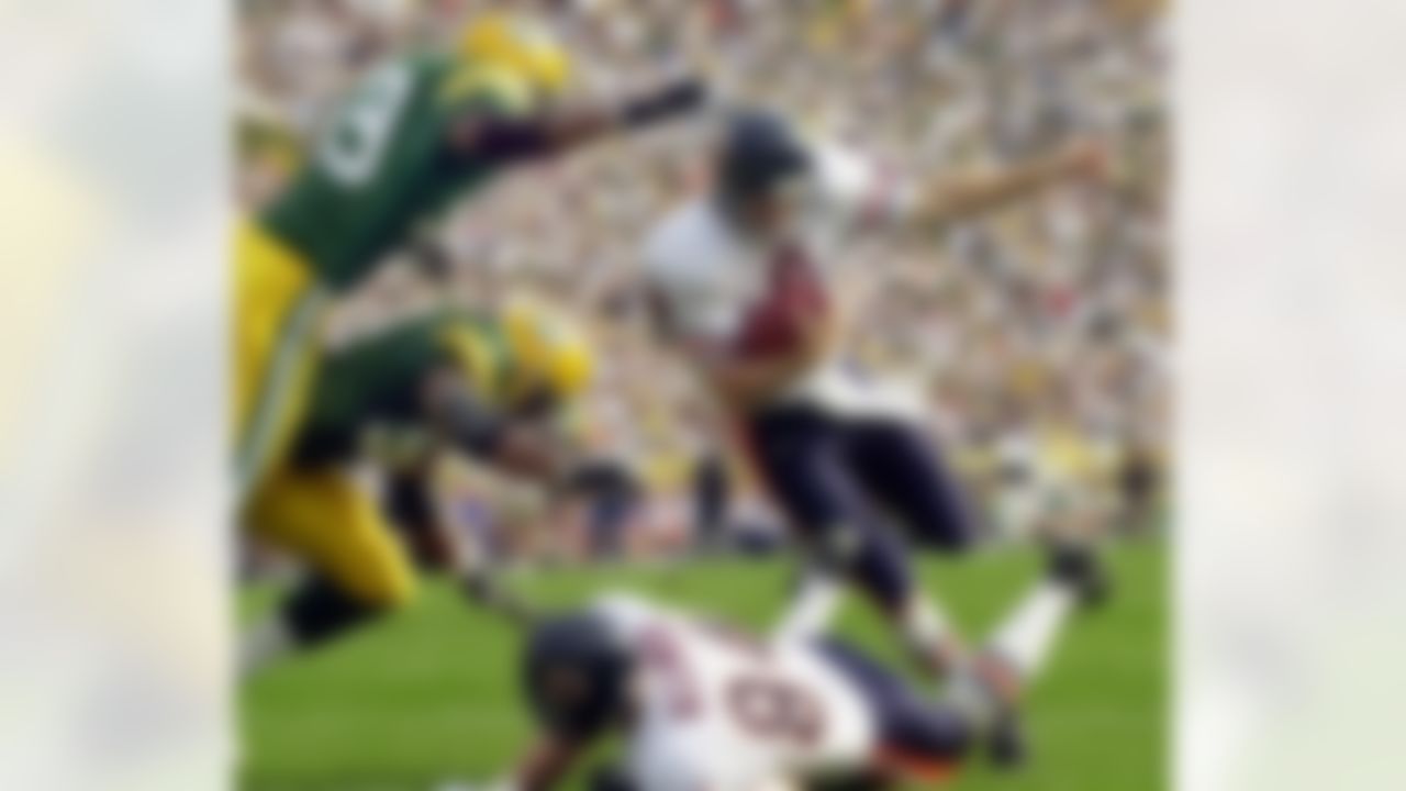 Chicago Bears quarterback Cade McNown (8) runs over John Allred (84) as he gets past Green Bay Packers' linebackers Nate Wayne (54) and Na'il Diggs (59) for a touchdown in the first quarter Sunday, Oct. 1, 2000, in Green Bay, Wis. (AP Photo/Mike Roemer)