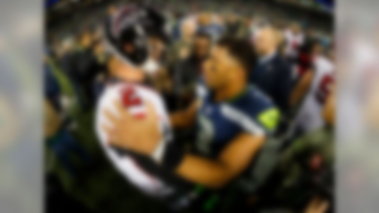 Atlanta Falcons quarterback Matt Ryan (2) and Seattle Seahawks quarterback Russell Wilson (3) meet after an NFL football game, Monday, Nov. 20, 2017, in Seattle. The Falcons defeated the Seahawks, 34-31.