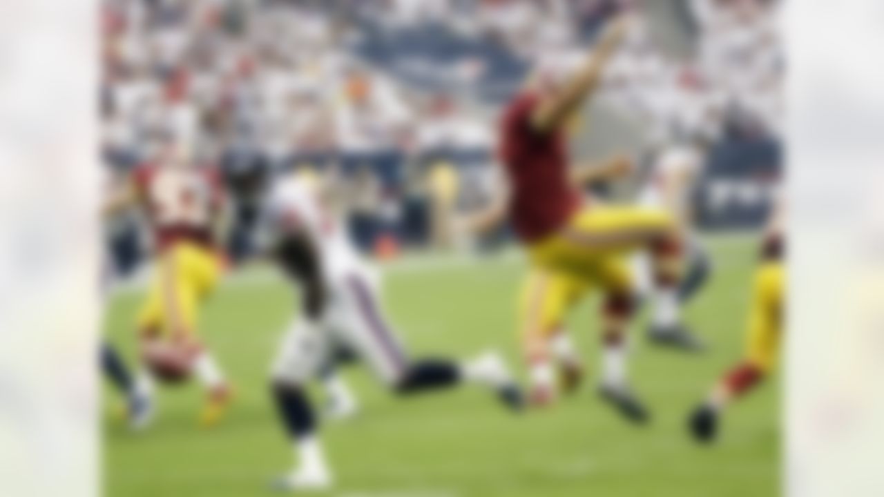 The Houston Texans' Alfred Blue (28) blocks a punt by the Washington Redskins' Tress Way. Blue recovered the blocked punt and scored on the play. (AP Photo/David J. Phillip)