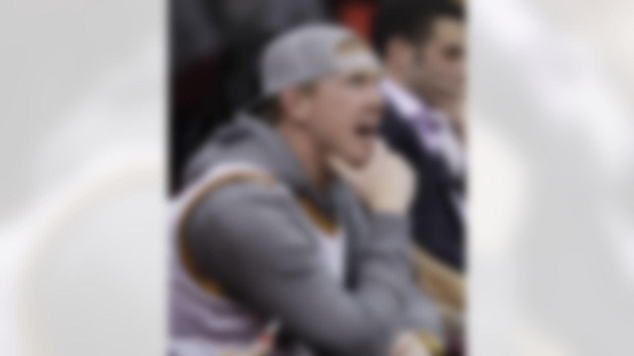 Cleveland Browns quarterback Brandon Weeden watches the Cleveland Cavaliers play the Phoenix Suns in an NBA basketball game Tuesday, Nov. 27, 2012, in Cleveland. The Suns won 91-78. (AP Photo/Tony Dejak)