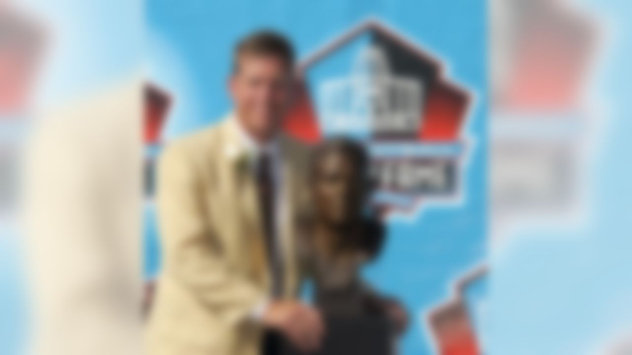 Former Dallas Cowboys great Troy Aikman poses with his bust after enshrinement into the Pro Football Hall of Fame Saturday, Aug. 5, 2006, in Canton, Ohio. (AP Photo/Mark Duncan)