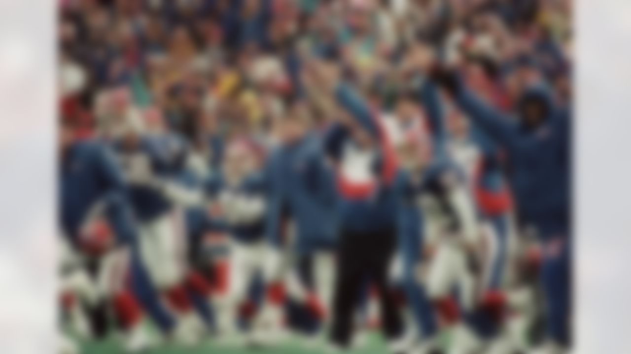 The Buffalo Bills bench, including receiver Don Beebe (82) and injured quarterback Jim Kelly, behind Beebe and wearing street clothes, celebrate Steve Christie's winning overtime field goal to beat the Houston Oilers 41-38, on Jan. 3, 1993, at Orchard Park. (AP Photo/Bill Sikes)