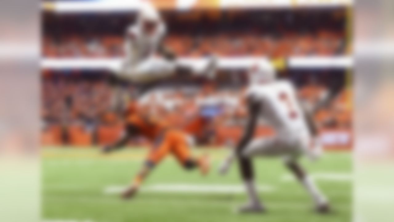 Sep 9, 2016; Syracuse, NY, USA; Louisville Cardinals quarterback Lamar Jackson (8) leaps over Syracuse Orange defensive back Cordell Hudson (20) during the second quarter at the Carrier Dome. Mandatory Credit: Rich Barnes-USA TODAY Sports