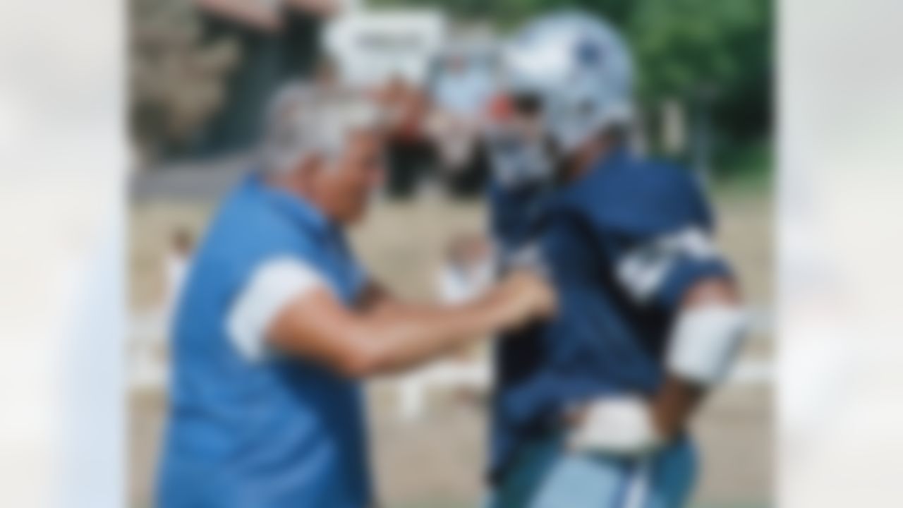 Dallas Cowboy defensive coordinator and line coach Ernie Stautner (left) explains a technique to free agent rookie Ken Sims during a practice session at Cowboy training camp in Thousand Oaks, California on Wednesday, July 9, 1986. Stautner was an All-Pro defensive end and tackle with the Pittsburgh Steelers. (AP Photo/Bob Galbraith)