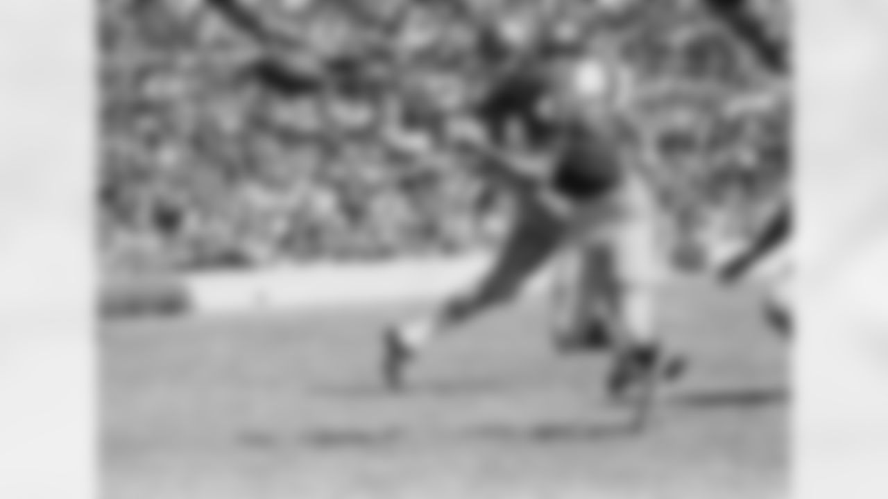 Jerry Wilson (41), SMU defensive safety man, reaches out to pick off a Navy pass intended for Tom Leiser, Navy halfback, during the first quarter of the game, Sept. 24, 1966, Dallas, Texas. Danny Wong, Navy fullback, comes in behind Wilson in an effort to halt the interception. (AP Photo/Robert D. Scott)