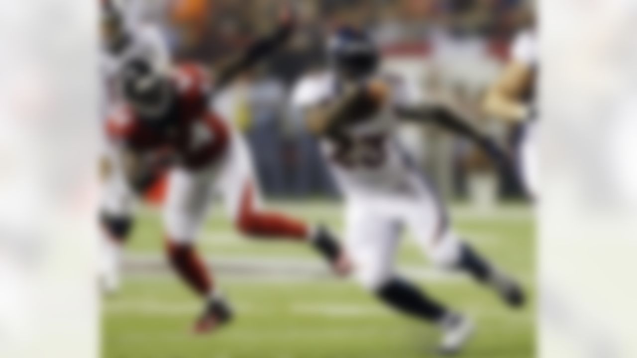 Denver Broncos running back Willis McGahee (23) rushes ahead of Atlanta Falcons linebacker Stephen Nicholas (54) during the first half of an NFL football game, Monday, Sept. 17, 2012, in Atlanta. (AP Photo/David Goldman)