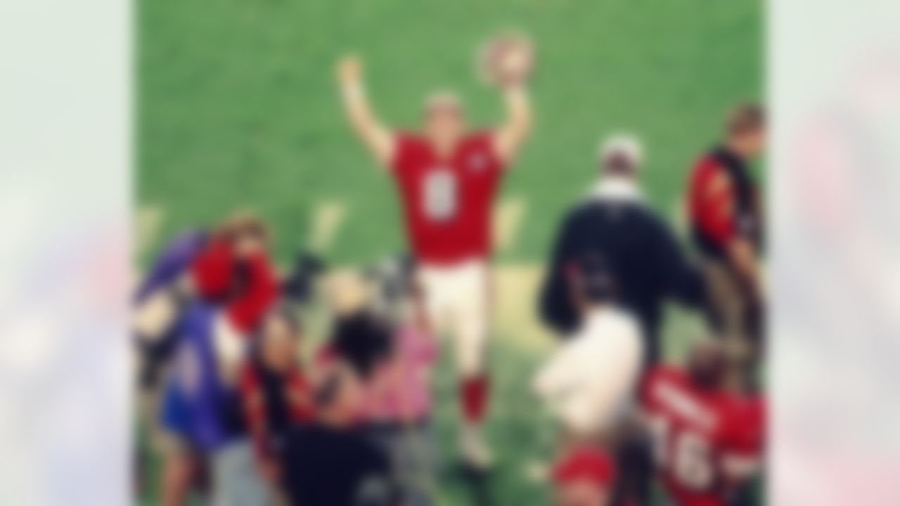 San Francisco 49ers quarterback Steve Young (8) celebrates on the sideline during the closing minutes of the NFL Super Bowl XXIX game against the San Diego Chargers on January 29, 1995, in Miami, Fla. Young was named MVP as the 49ers defeated the Chargers 49-26. (AP Photo/Kevin Terrell)