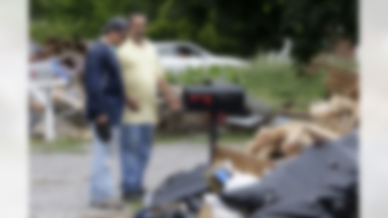 Donald Meadows, right, shows Tennessee Titans head coach Jeff Fisher, left, the debris taken out of Meadows' home as players, coaches and staff of the Titans help clean up flood-damaged homes on Wednesday, May 12, 2010, in Nashville, Tenn. (AP Photo/Mark Humphrey)