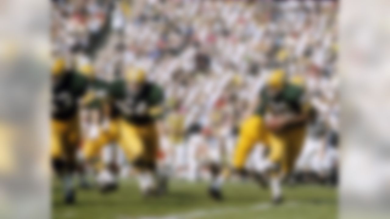 Green Bay Packers running back Elijah Pitts (22) follows guards Fuzzy Thurston (63) and Jerry Kramer (64) on the famed Packers Sweep during Super Bowl I, a 35-10 victory over the Kansas City Chiefs on January 15, 1967, at the Los Angeles Memorial Coliseum (National Football League)