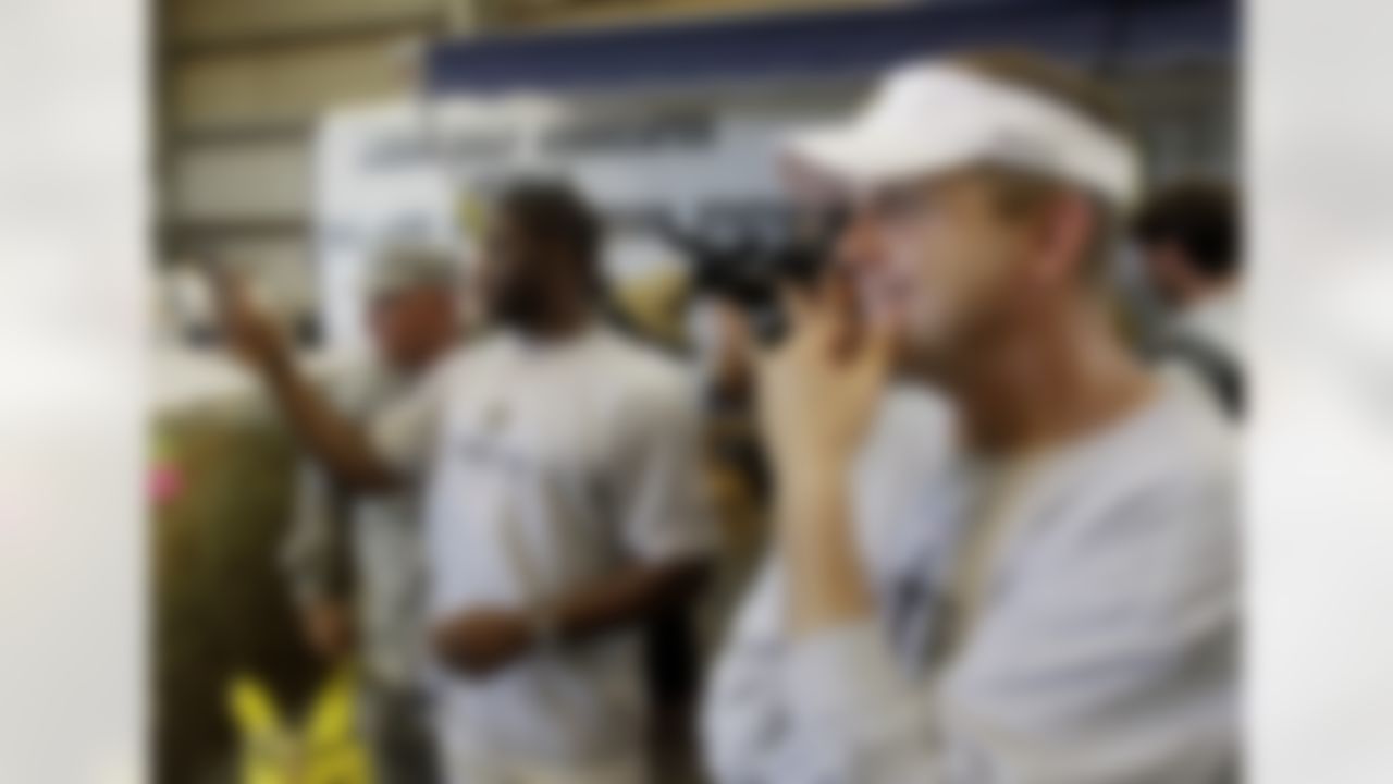 New Orleans Saints coach Sean Payton, right, and running back Reggie Bush, left, visit the International Bird Rescue Research Center in Tuesday, June 8, 2010 in Buras, La.. The Saints made a visit to the to the area to boost moral and visit the area. (AP Photo/Eric Gay)