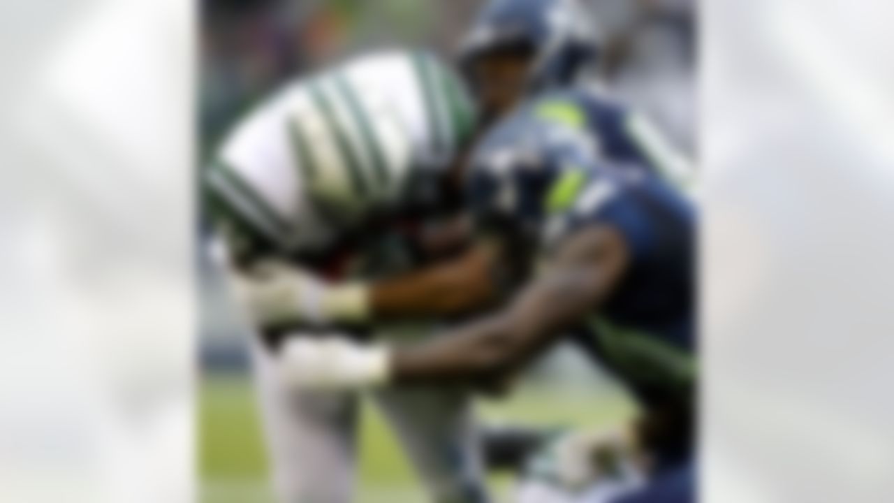 New York Jets' Shonn Greene, left, is hit by Seattle Seahawks' Mike Morgan, upper right, and Kam Chancellor, lower right, during the second half of an NFL football game, Sunday, Nov. 11, 2012, in Seattle. The Seahawks won 28-7. (AP Photo/Stephen Brashear)