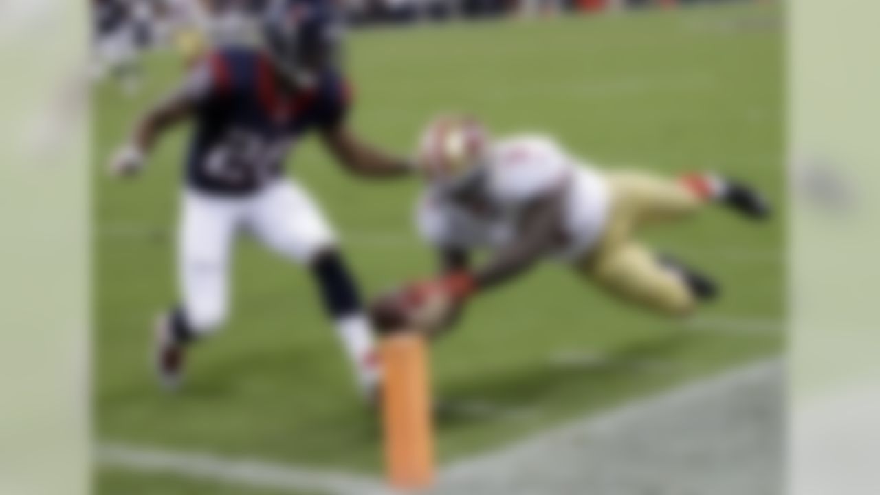 San Francisco 49ers' Bruce Ellington (3) dives past Houston Texans' Brandon Harris (26) for a touchdown during the second quarter of an NFL football preseason game Thursday, Aug. 28, 2014, in Houston. (AP Photo/David J. Phillip)