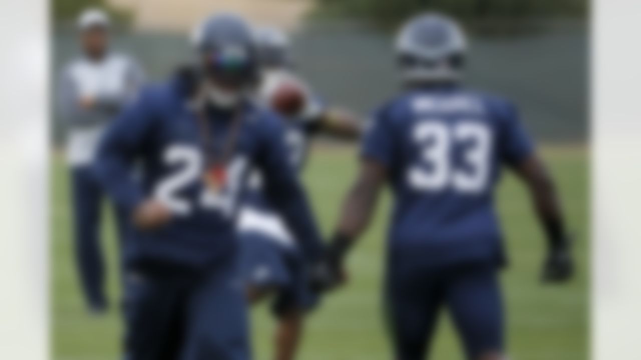 Seattle Seahawks' Marshawn Lynch (24) low-fives teammate Christine Michael (33) as they run drills during a team practice for NFL Super Bowl XLIX football game, Wednesday, Jan. 28, 2015, in Tempe, Ariz. The Seahawks play the New England Patriots in Super Bowl XLIX on Sunday, Feb. 1, 2015. (AP Photo/Matt York)