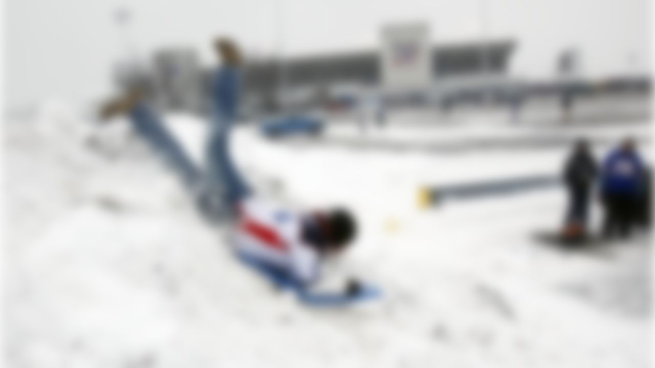 Buffalo Bills fan Justin Rankin sleds off a snow pile in the parking lot before the NFL football game against the Indianapolis Colts in Orchard Park, N.Y., Sunday, Jan. 3, 2010. (AP Photo/ David Duprey)