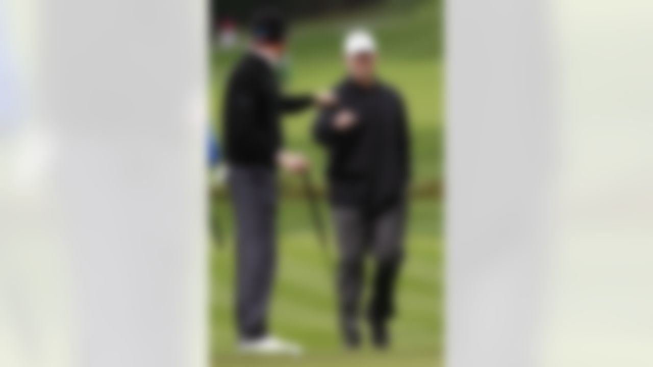 Green Bay Packers NFL football quarterback Aaron Rodgers, right, celebrates with D.J. Trahan after hitting to the second hole at Pebble Beach Golf Links during the third round of the Pebble Beach National Pro-Am golf tournament in Pebble Beach, Calif., Saturday, Feb. 11, 2012. (AP Photo/Jeff Chiu)