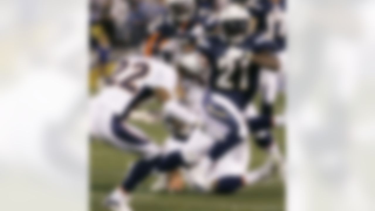 San Diego Chargers' LaDainian Tomlinson, right, cuts away from Denver Broncos' Dominique Foxworth on his touchdown run in the first quarter of their NFL football game Monday, Dec. 24, 2007, in San Diego. (AP Photo/Denis Poroy)