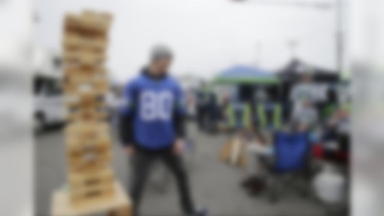 Seattle Seahawks fans play a wooden block stacking game as they tailgate before an NFL football NFC wild card playoff game between the Seahawks and the Detroit Lions, Saturday, Jan. 7, 2017, in Seattle. (AP Photo/Stephen Brashear)