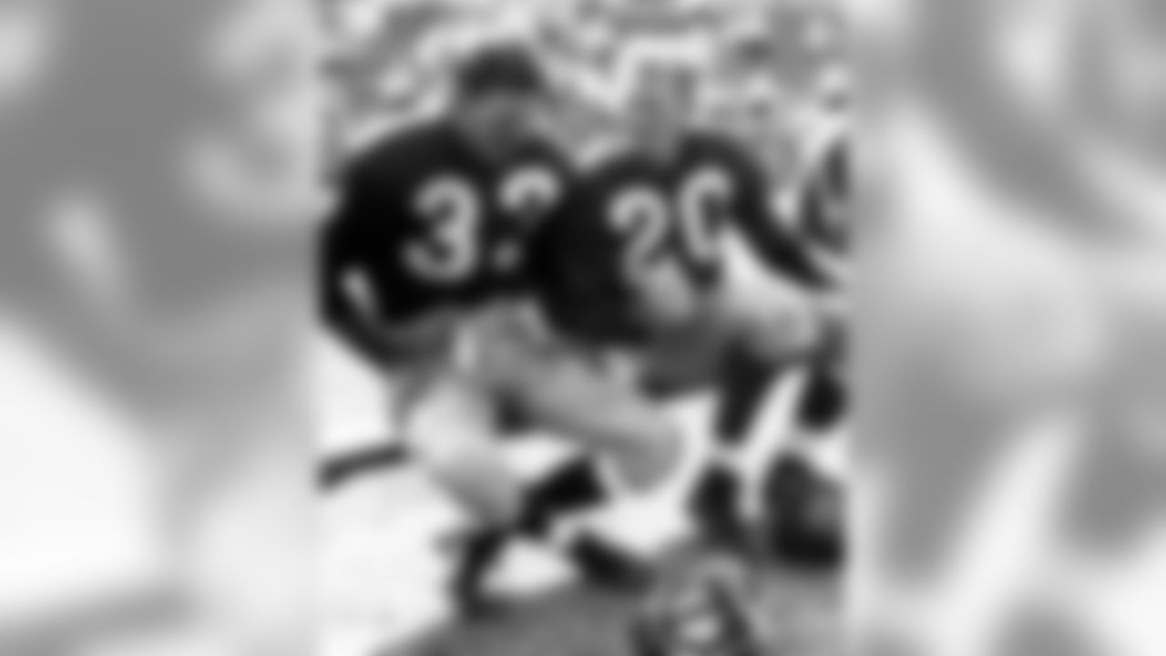 Washington Redskins Hall of Fame quarterback Sammy Baugh and halfback Dan Sandifer on the bench during training camp circa 1948. (Nate Fine/NFL)