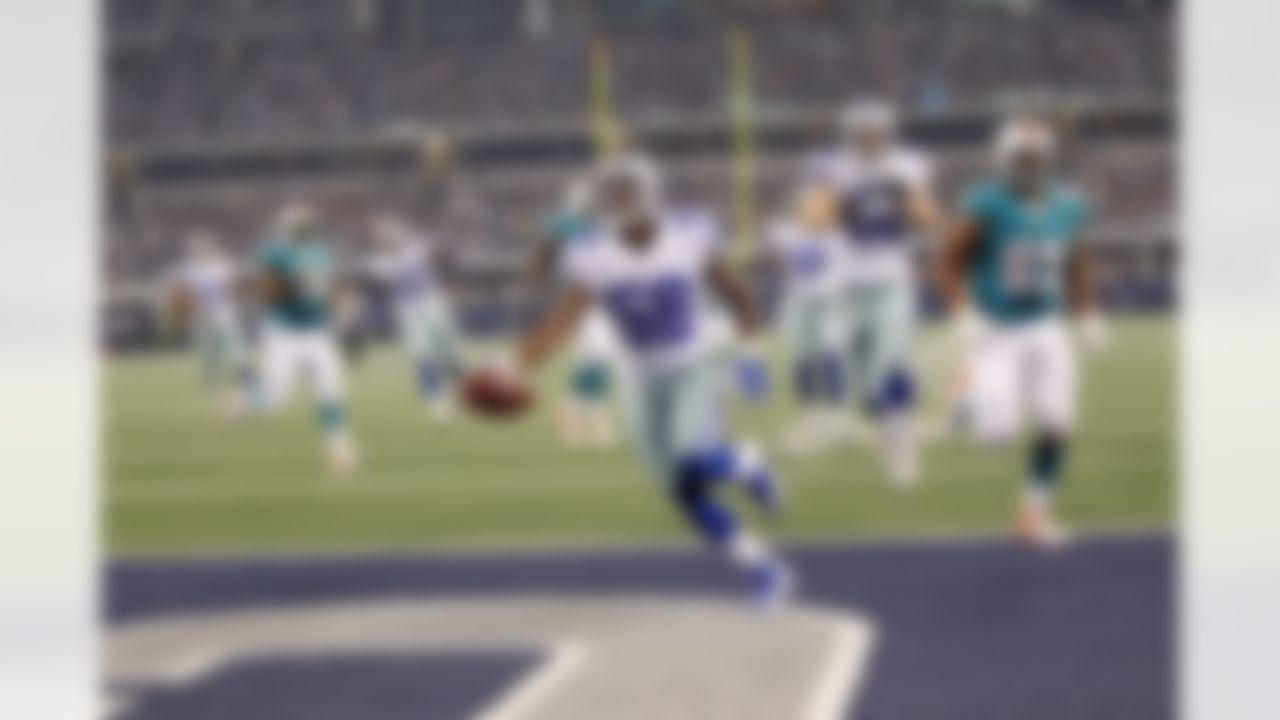 Dallas Cowboys linebacker Orie Lemon (58) returns an interception 26 yards for a touchdown during an NFL preseason football game against the Miami Dolphins in Arlington, Texas on Wednesday, August 29, 2012, at Cowboys Stadium. The Cowboys defeated the Dolphins, 30-13. (AP Photo/James D Smith)