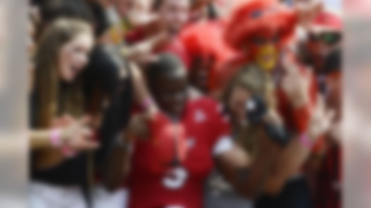 Louisville quarterback Teddy Bridgewater celebrates with the fans after a 44-7 win over Eastern Kentucky at Papa John's Cardinal Stadium  (Jamie Rhodes/USA TODAY Sports)