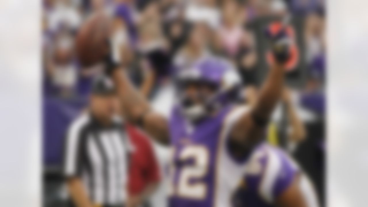Minnesota Vikings wide receiver Percy Harvin (12) celebrates after making a touchdown in the first half of an NFL football game against the Arizona Cardinals in Minneapolis, Sunday, Oct. 21, 2012. (AP Photo/Andy King)
