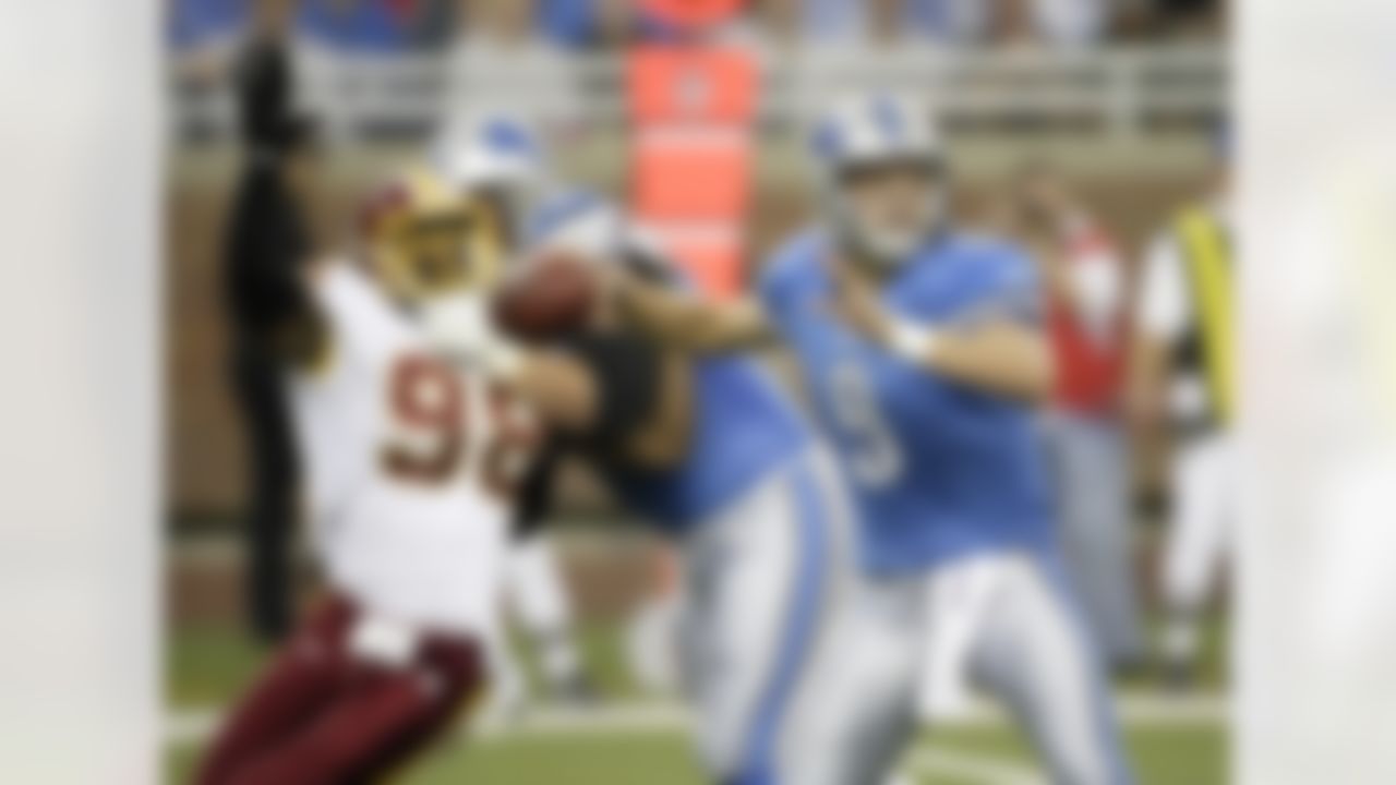 Detroit Lions quarterback Matthew Stafford (9) looks to pass as Washington Redskins' Brian Orakpo (8) is held off by a teammate in an NFL football game Sunday, Sept. 27, 2009 in Detroit. (AP Photo/Duane Burleson)
