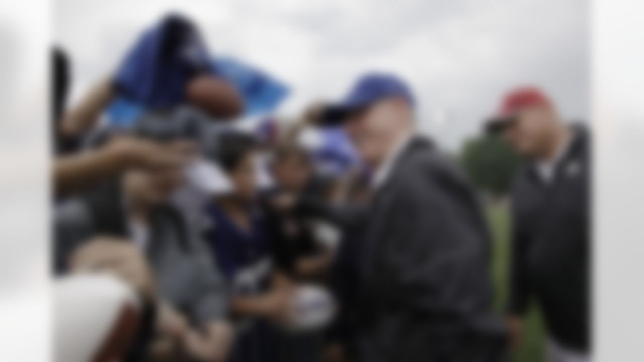 New York Giants head coach Tom Coughlin reacts to fans as he signs autographs at the New York Giants NFL football training camp in Albany, N.Y., Saturday, July 28, 2012. (AP Photo/Kathy Willens)