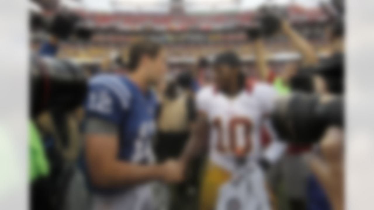 Indianapolis Colts quarterback Andrew Luck, left, greets Washington Redskins quarterback Robert Griffin III after an NFL preseason football game Saturday, Aug. 25, 2012, in Landover, Md. The Redskins won 30-17. (AP Photo/Alex Brandon)