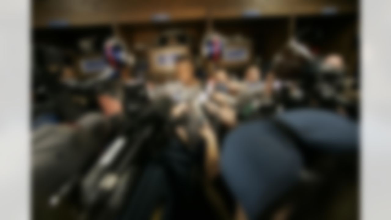 New York Giants' Plaxico Burress is surrounded by reporters in the team's locker room at Giants stadium Monday, Nov. 27, 2006 in East Rutherford, N.J. (AP Photo/Mary Altaffer)