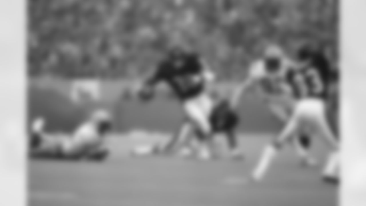 Chicago Bears running back Walter Payton cuts up field for a seven yard gain while being pursued by Green Bay Packers Robert Brown (93) during action, Sunday, Dec. 10, 1984 in Chicago. Payton rushed 35 times for 175-yards, scored one touchdown, passed for another and played one series as quarterback. The Packers defeated the Bears 20-14. (AP Photo/John B. Swart)