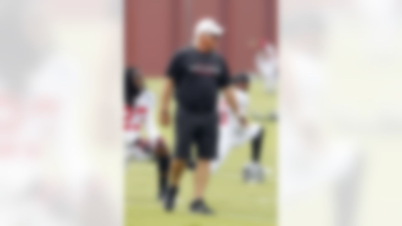 Atlanta Falcons head coach Mike Smith chats with his players during an NFL football training camp in Flowery Branch, Ga., Tuesday, July 31, 2012. (AP Photo/John Bazemore)