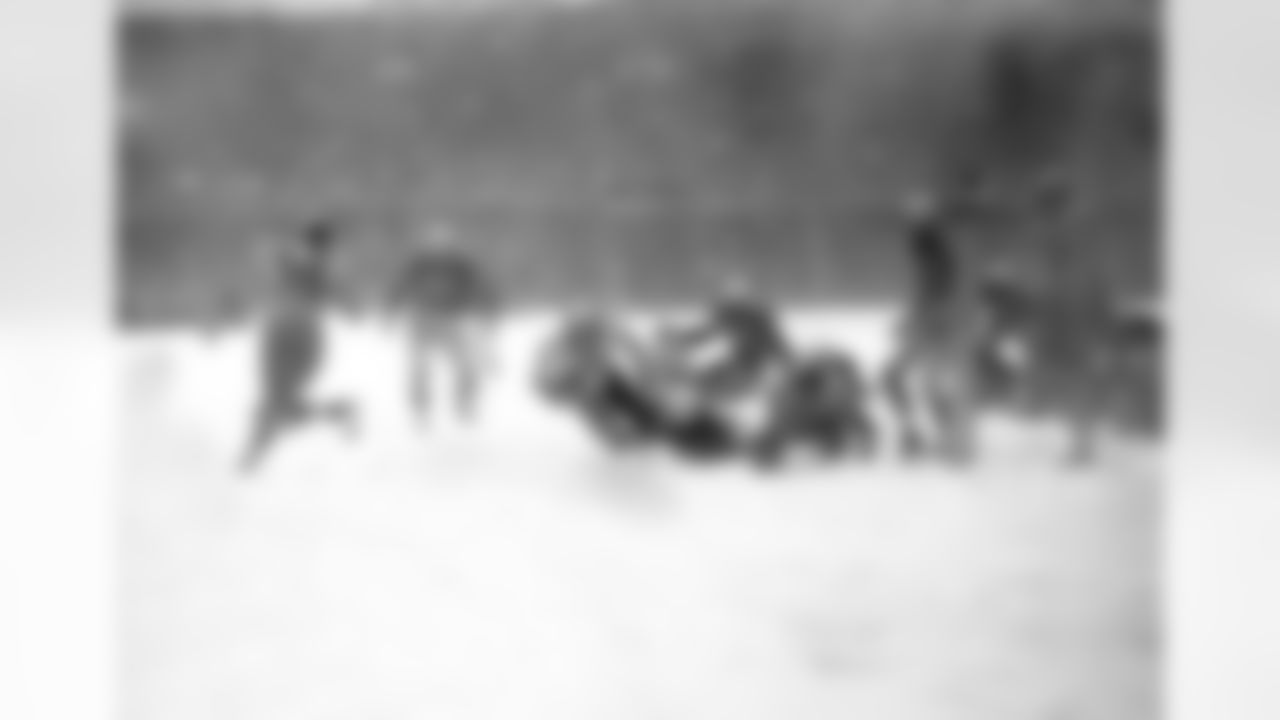 Steve Van Buren (15) of the Philadelphia Eagles plunges over the goal line with a fourth period touchdown that defeated the Chicago Cardinals in the driving snowstorm in Philadelphia, Pa., Dec. 1948. Other players are, Bill Blackburn (57) and John Cochrane (24) of the Cardinals. (AP Photo)