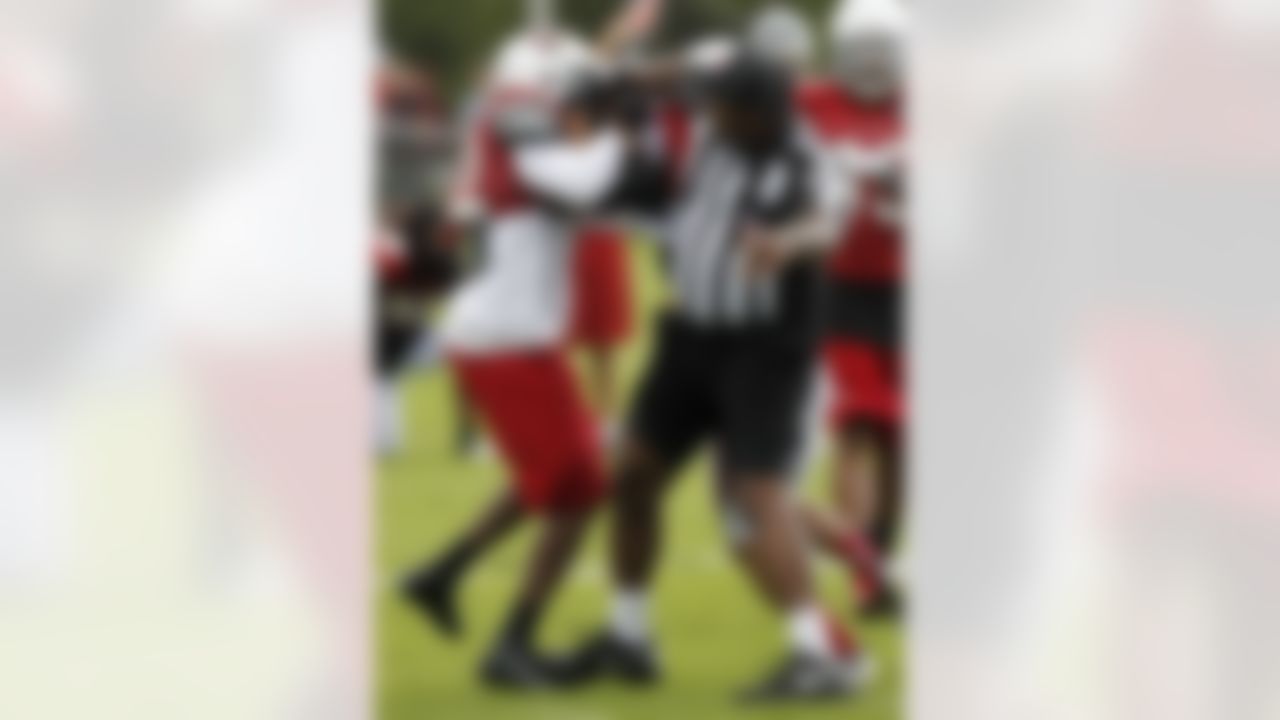 An official tries to break up a shoving match between Arizona Cardinals' Crezdon Butler, left, and Tre Gray during NFL football training camp at Northern Arizona University, Thursday, July 26, 2012, in Flagstaff, Ariz. (AP Photo/Ross D. Franklin)