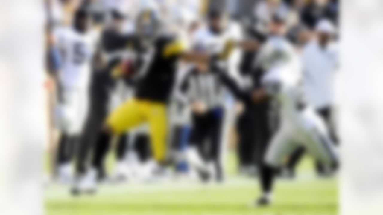 Oakland Raiders cornerback Stanford Routt (26) pushes Pittsburgh Steelers wide receiver Mike Wallace (17) out of bounds after Wallace ran the ball on a double reverse during the second quarter of an NFL football game Sunday, Nov. 21, 2010 in Pittsburgh. (AP Photo/Don Wright)