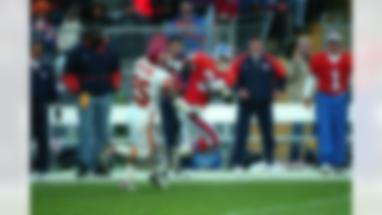 Denver Broncos running back Terrell Davis runs for yardage as he stiff-arms Kansas City Chiefs safety Mark Collins on October 27, 1996 in Denver, Colorado. The Broncos defeated the Chiefs 34-7. (AP Photo/G. Newman Lowrance)
