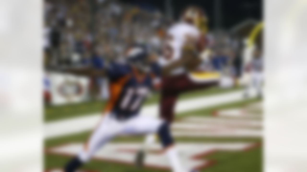 Washington Redskins safety Sean Taylor, right, intercepts a pass in front of Denver Broncos wide receiver Darius Watts in the second quarter during the Pro Football Hall of Fame game at Fawcett Stadium Monday, Aug. 9, 2004, in Canton, Ohio. (AP Photo/Ron Schwane)