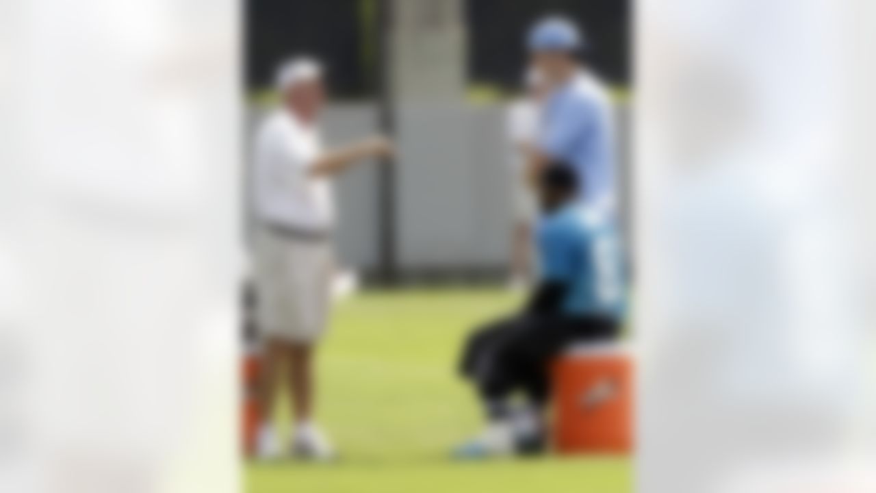 Carolina Panthers' Steve Smith, bottom right, and tennis player John Isner, top right, talk with head coach John Fox, left, during football practice in Charlotte, N.C., Wednesday, June 2, 2010. (AP Photo/Chuck Burton)