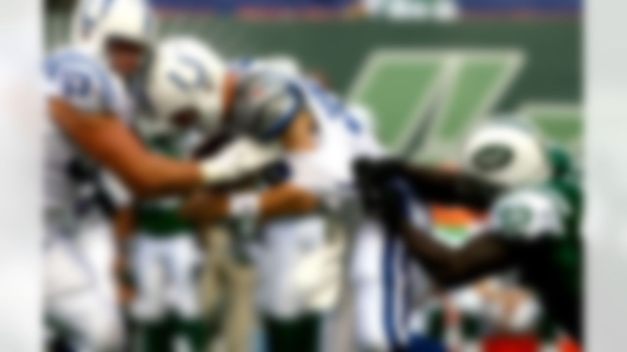 EAST RUTHERFORD, NJ - OCTOBER 01: Quarterback Peyton Manning #18 of the Indianapolis Colts is taken down by Shaun Ellis #92 of the New York Jets on October 1, 2006 at Giants Stadium in East Rutherford, New Jersey. Photo by Al Bello/Getty Images.