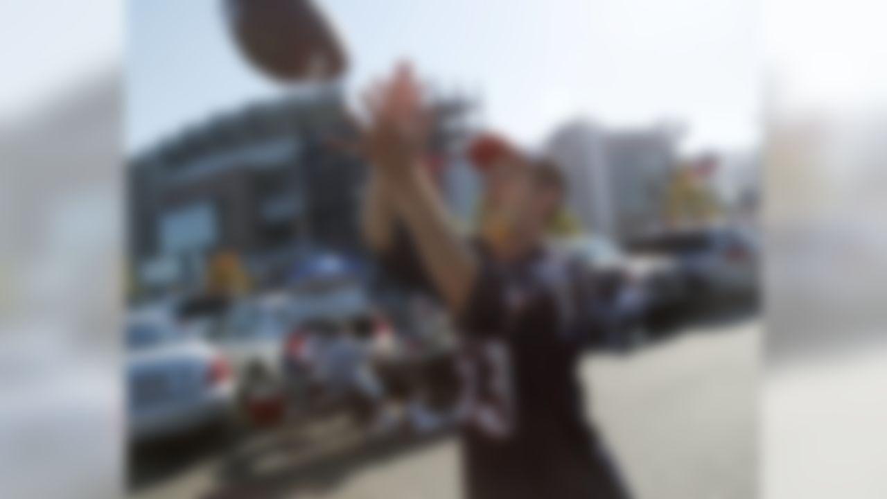 Jeremy Martin of Boston catches a pass while tailgating prior to the New England Patriots facing the New York Jets in an NFL football game in Foxborough, Mass., Sunday, Oct. 9, 2011. (AP Photo/Charles Krupa)